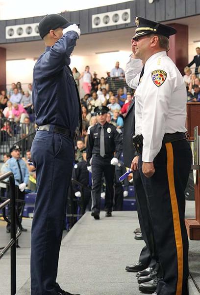 Monmouth County Sheriff Shaun Golden salutes a graduate of the 84th Class of Basic Course for Police Officers from the Monmouth County Police Academy Graduation at Brookdale Community College on May 23, 2013. There were 66 recruits in the class .